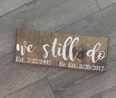 a wooden sign that says we still do