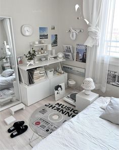 a bedroom with white furniture and lots of windows