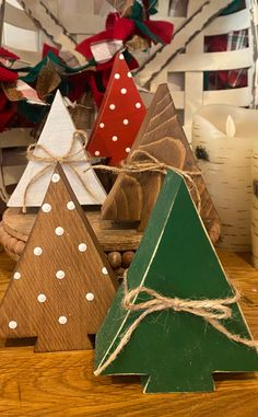 three wooden christmas trees on a table