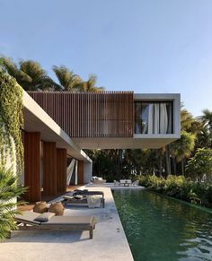 an outdoor swimming pool next to a house