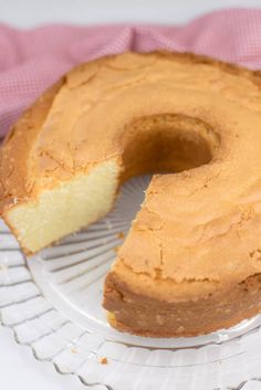 a bundt cake on a plate with one slice cut out and ready to be eaten