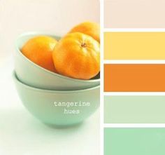 two oranges in a white bowl on top of a table next to color swatches