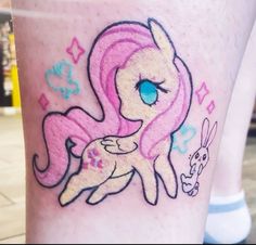 a close up of a person's leg with a tattoo on it and an image of a pony