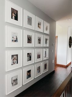 a wall with many pictures hanging on it