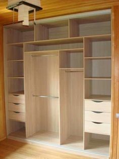 an empty walk in closet with white drawers