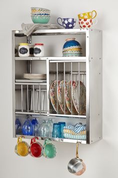 a metal shelf with plates and bowls hanging from it