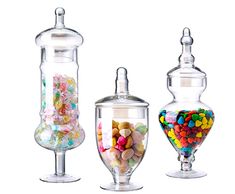 three glass jars filled with different types of candy