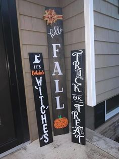 two wooden signs that say fall and trick or treat on the side of a house