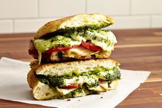 two sandwiches stacked on top of each other with cheese and broccoli in the middle