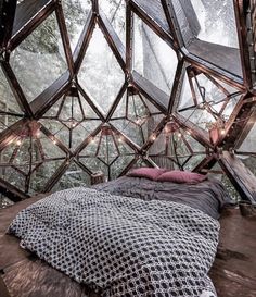 the inside of a geoglyic tent with lights strung from it's ceiling