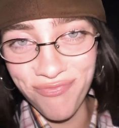 a close up of a person wearing glasses and a hat