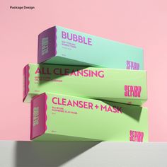 three boxes are stacked on top of each other, one is pink and the other is green