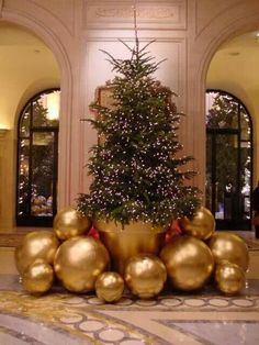 a christmas tree with gold balls in the middle