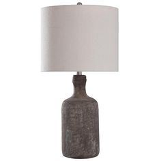 a gray table lamp with a white shade