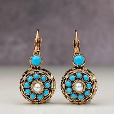 We loved our rose model imitation diamond earrings from the Ottoman period and enjoyed making them. We both brought back an element of our culture and that reminds us the past. We tried to create a diamond look with turquoise crystal stones in our Ottoman rose model imitation diamond bronze earrings. In our Anatolian culture, we used to see these earrings in our grandmothers at a young age, and they were handed down to our mother as a legacy from them and later to us. We are currently trying to Vintage Earrings With Intricate Design, Ornate Bronze Earrings, Elegant Turquoise Nickel-free Flower Earrings, Elegant Turquoise Drop Flower Earrings, Elegant Turquoise Flower Earrings Nickel Free, Elegant Turquoise Flower Drop Earrings, Elegant Turquoise Flower Earrings, Antique Blue Earrings, Turquoise Brass Earrings