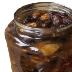 a jar filled with lots of food sitting on top of a table