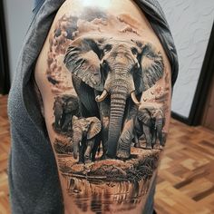 an elephant tattoo on the back of a man's arm