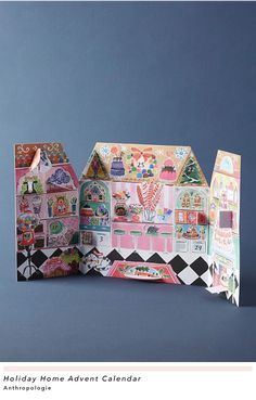 a paper doll house with lots of stickers on the front and back sides, open