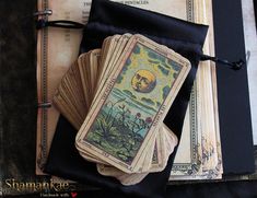 four tarot cards sitting on top of an open book