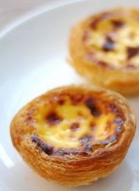 two small pastries sitting on top of a white plate