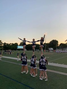 the cheerleaders are doing stunts on the field