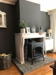 a living room with a fire place in the corner and a rug on the floor