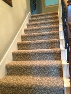 the stairs are lined with carpet and wood