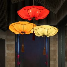 three red and yellow lanterns hanging from the ceiling