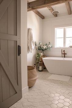 a bathroom with a white tub and wooden ceiling