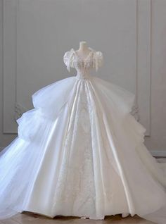 a white wedding dress on display in a room