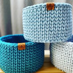 three crocheted baskets sitting next to each other