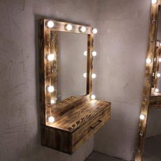 a wooden vanity with lights on it in front of a mirror and light up stool