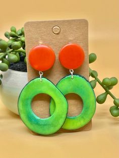 Elevate your jewelry collection with our Tagua Nut Loop Dangle Drop Earrings, crafted from eco-friendly tagua nuts, also known as vegetable ivory. These earrings feature a chic loop design and dangle drop style, available in a variety of bold colors and shapes, adding a stylish boho touch to any outfit. Each earring includes two different small oval or round studs, with a size of 15 mm for a comfortable fit. Available in both clip-on and pierced options, these earrings are designed to be incredi Boho Mode, Loop Design, Tagua Nuts, Boho Chic Jewelry, Eco Friendly Jewelry, Earrings Stud, Chic Jewelry, Wooden Earrings, Earrings Boho