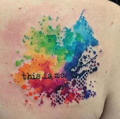 the back of a woman's shoulder with colorful ink splattered on it