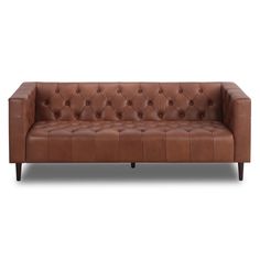 a brown leather couch with buttons on the back and arms, sitting against a white background