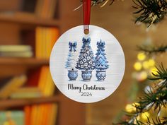 a christmas ornament hanging from a tree in front of a bookshelf