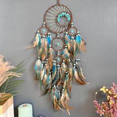 there is a wall hanging made out of feathers with beads and beads on the side