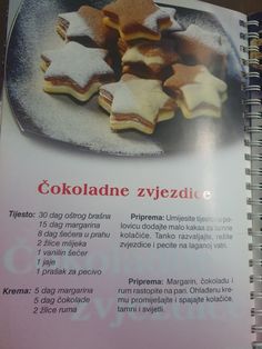 the recipe book is open and ready to be eaten with star shaped cookies on it