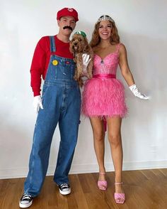 a man and woman in costumes pose for a photo