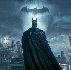 the dark knight in batman ark is standing on top of a building with city lights behind him