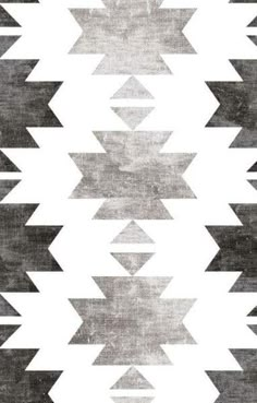 a black and white rug with an arrow pattern on it's side, in the middle