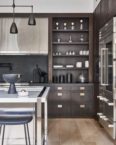 a modern kitchen with stainless steel appliances and wood flooring