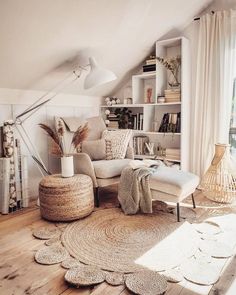 a living room filled with lots of furniture and rugs on top of a hard wood floor