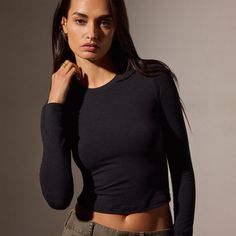 Our Long Sleeve Cropped Tee is made from a cotton blend of Japanese fabric that has been dyed to give the garment extra texture and an extremely soft hand feel. Style is fitted to the body but the blended fabric offers stretch. Style details include a clean, smooth hand, sits at your natural waist, and can see color high and lows. Fitted.Additional Information:• 65% Cotton, 28% Polyester, 7% Polyurethane • Machine wash cold, tumble dry low Sporty Washed Black Long Sleeve Top, Black Cotton Long Sleeve Activewear, Black Stretch Cropped Long Sleeve Top, Black Long Sleeve Stretch T-shirt, Black Long Sleeve Soft-washed T-shirt, Denim Polo, Sweat Top, Jumpsuit Skirt, Japanese Fabric