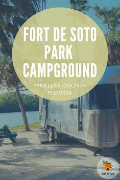 a camper parked in front of a lake with the words fort de sotto park campground