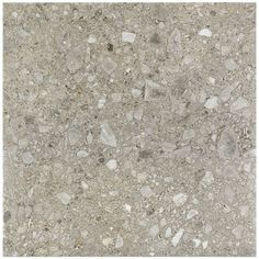 a close up view of the surface of a concrete floor with small rocks and gravel