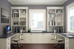 a home office with two desks and bookshelves