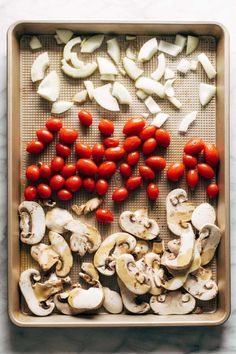 tomatoes, mushrooms and garlic on a baking sheet