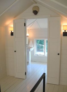 an open door leading into a white room