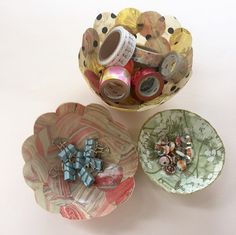 three bowls with various items in them on a table